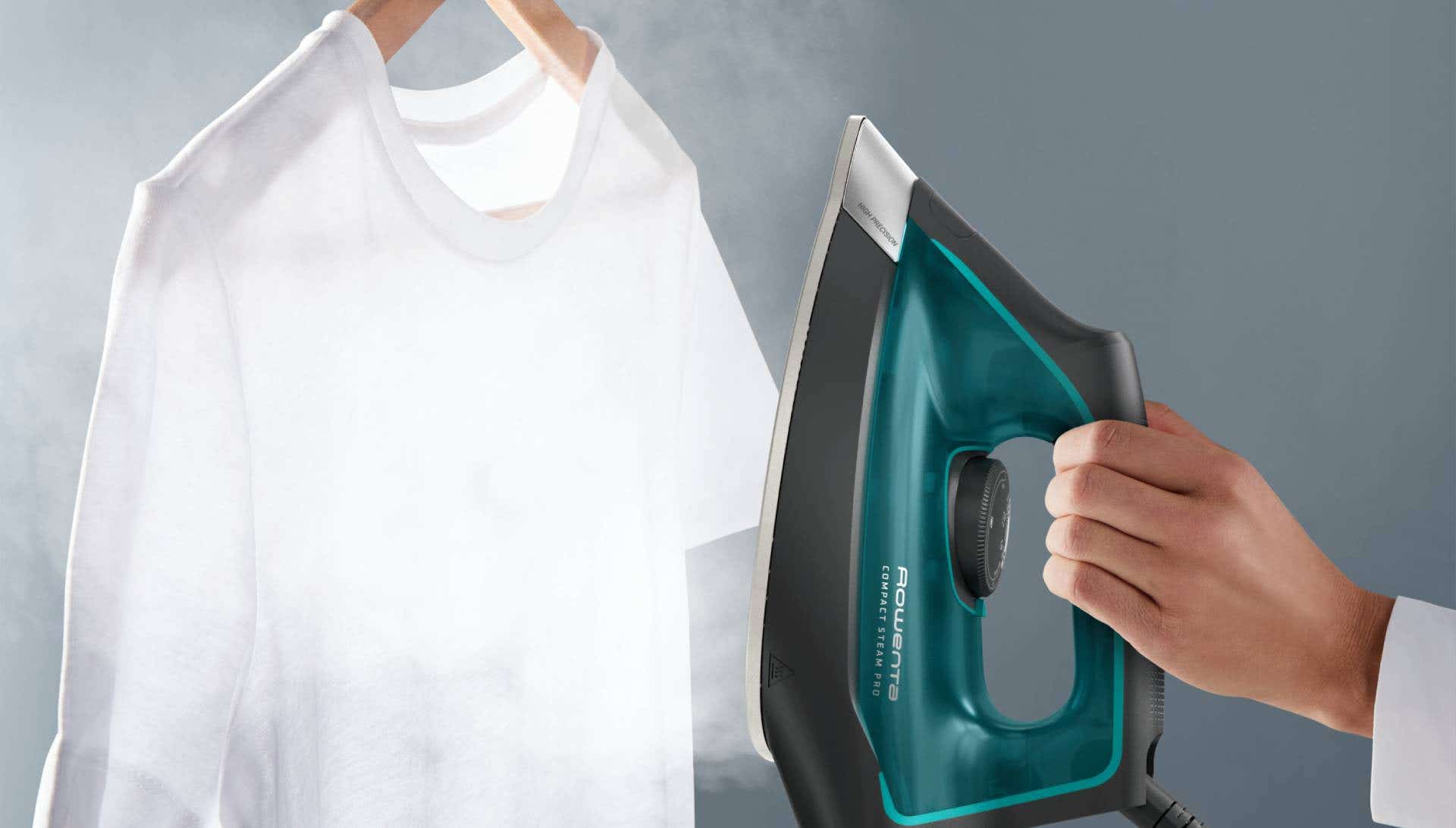 A person ironing a shirt on an ironing board with a steam iron, focusing on removing wrinkles from the fabric.