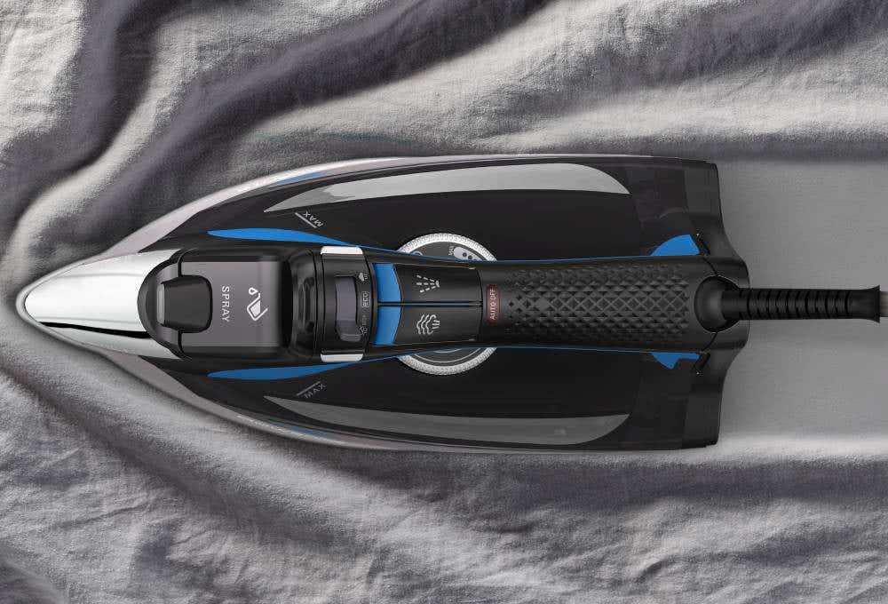 A black and blue steam iron , illustrating its purpose for smoothing out wrinkles in fabric.